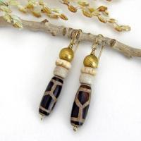 These handmade earrings feature Tibetan agate beads with a brown and tan tribal pattern accented with African beige glass and carved bone beads topped off with gold brass beads. Unique and fun to wear - they'll add a boho tribal flair to your wardrobe. Handmade in the USA by Desert Earth Jewelry.