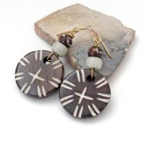 Handmade earrings with large round African batik bone beads with a carved tribal pattern accented with smaller African carved bone beads and African glass beads. 