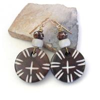 These handmade earrings feature large round African batik bone beads with a carved tribal pattern accented with smaller African carved bone beads and African glass beads. They have an exotic, ethnic tribal style and are sure to make a bold striking statement.