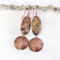 Natural African map jasper stones are accented with hammered copper dangles in these earthy handmade earrings. This type of jasper gets its name because it exhibits the colors and patterns that resemble the markings of the giraffes, cheetahs and other jungle cats that roam Africa. Each stone has its own unique patterns and this pair is no exception with wonderful markings in earthy hues of tan, mossy green, rust, beige and brown.