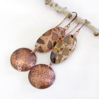 Natural African map jasper stones are accented with hammered copper dangles in these earthy handmade earrings. This type of jasper gets its name because it exhibits the colors and patterns that resemble the markings of the giraffes, cheetahs and other jungle cats that roam Africa. Each stone has its own unique patterns and this pair is no exception with wonderful markings in earthy hues of tan, mossy green, rust, beige and brown.