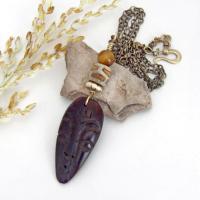 This handcrafted necklace features a carved wood African mask accented with a giraffe print etched agate, golden tiger's eye gemstones and an African carved bone bead. Unique and striking, it'll make a great gift for someone that loves one-of-a-kind ethnic inspired jewelry! It comes on an 18” antiqued brass chain with sturdy hook & eye closure.  Makes a great gift for a man or women that loves African art!