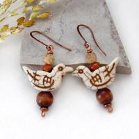 These handmade earrings feature creamy beige magnesite stone birds. They are accented with brown jasper, picture jasper, brown wood and tiny copper beads. Super cute, whimsical and fun to wear -- they'll make a great gift for a nature / bird lover! Your choice of ear wires - copper or hypoallergenic niobium.