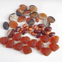 Mixed bead lot for jewelry making / beading / craft supply.  Lot consists of 14 pieces of oval-shaped banded agate beads (black orange white tones with various matrix patterns). Measures approximately 7/8" to 1" in length and 3/4" in width - drilled top to bottom. 12 pieces of burnt orange seashell shaped beads. Measures approximately 1" at widest point and 3/4" in length - drilled top to bottom 9 bright orange organically shaped freshwater pearl beads - drilled 8 dark reddish-brown dried bean beads