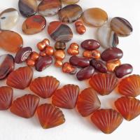Mixed bead lot for jewelry making / beading / craft supply.  Lot consists of 14 pieces of oval-shaped banded agate beads (black orange white tones with various matrix patterns). Measures approximately 7/8" to 1" in length and 3/4" in width - drilled top to bottom. 12 pieces of burnt orange seashell shaped beads. Measures approximately 1" at widest point and 3/4" in length - drilled top to bottom 9 bright orange organically shaped freshwater pearl beads - drilled 8 dark reddish-brown dried bean beads