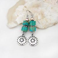 These handmade dangle earrings feature silver tone pewter concho charms accented with a stack of turquoise stones and pewter beads. Lightweight and fun to wear, they'll add a touch of southwestern charm to your wardrobe. Perfect for women that love southwest and sundance style jewelry. 