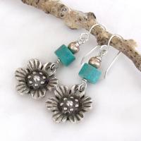 These handcrafted earrings feature silver tone pewter flowers accented with turquoise stones and round pewter beads. The flowers have a beautiful 3-dimensional design with lots of great detail. They'll make a great gift for a gardener, nature or flower lover.