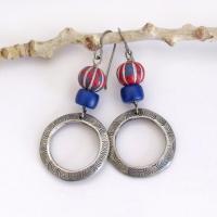 These handcrafted earrings feature silver pewter circle hoops with a hand stamped texture accented with red, white and blue carved clay beads and navy blue glass beads. They have an earthy, boho style and are lightweight and comfortable to wear. Great patriotic USA colors. Artisan handmade in the USA jewelry. 