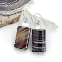 Simple, yet elegant - these earrings feature natural sardonyx gemstones with a striking natural black and white striped pattern accented with white moonstones. Sardonyx is a type of agate formed when minerals form in between strips of black onyx which gives the stone a banded, "striped" appearance. The modern, elegant style will look great dressed up or down. They'll make a great gift for someone with an August birthday - sardonyx is the original and oldest recorded birthstone for August.