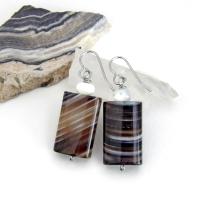 Simple, yet elegant - these earrings feature natural sardonyx gemstones with a striking natural black and white striped pattern accented with white moonstones. Sardonyx is a type of agate formed when minerals form in between strips of black onyx which gives the stone a banded, "striped" appearance. The modern, elegant style will look great dressed up or down. They'll make a great gift for someone with an August birthday - sardonyx is the original and oldest recorded birthstone for August.
