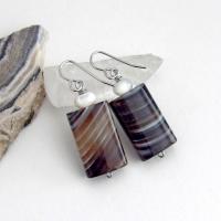 Simple, yet elegant - these earrings feature natural sardonyx gemstones with a striking natural black and white striped pattern accented with white moonstones. Sardonyx is a type of agate formed when minerals form in between strips of black onyx which gives the stone a banded, "striped" appearance. The modern, elegant style will look great dressed up or down. They'll make a great gift for someone with an August birthday - sardonyx is the original and oldest recorded birthstone for August.