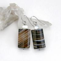 Simple, yet elegant - these earrings feature natural sardonyx gemstones with a striking natural black and white striped pattern accented with white moonstones. Sardonyx is a type of agate formed when minerals form in between strips of black onyx which gives the stone a banded, "striped" appearance. The modern, elegant style will look great dressed up or down. They'll make a great gift for someone with an August birthday - sardonyx is the original and oldest recorded birthstone for August.