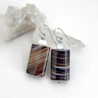 Simple, yet elegant - these earrings feature natural sardonyx gemstones with a striking natural black and white striped pattern accented with white moonstones. Sardonyx is a type of agate formed when minerals form in between strips of black onyx which gives the stone a banded, "striped" appearance. The modern, elegant style will look great dressed up or down. They'll make a great gift for someone with an August birthday - sardonyx is the original and oldest recorded birthstone for August.