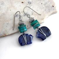 Small and cute, these zuni bear earrings feature natural blue sodalite gemstones carved into zuni bear shapes wrapped in steel wire and accented with turquoise heishi and silver tone pewter beads. They'll make a great gift for an animal / bear lover or anyone that loves southwestern style! These carved stone animals are believed by the Zuni people to hold the living spirit and power of the bear which represents healing, protection, introspection, and is the revered Guardian of the West.