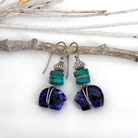 Small and cute, these zuni bear earrings feature natural blue sodalite gemstones carved into zuni bear shapes wrapped in steel wire and accented with turquoise heishi and silver tone pewter beads. They'll make a great gift for an animal / bear lover or anyone that loves southwestern style! These carved stone animals are believed by the Zuni people to hold the living spirit and power of the bear which represents healing, protection, introspection, and is the revered Guardian of the West.