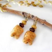 Super cute and fun to wear - these handmade earrings feature yellow jasper stones carved into sweet, little turtles. They are accented with fossilized beige coral and brown bronzite stone beads. They'll make a great gift for a turtle or animal lover. Turtles are powerful symbols of patience, wisdom, longevity and protection across many global cultures. Because of their hard shells and long lifespans, they represent stability and endurance, reminding us to move through life with steady determination.