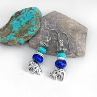 Small and cute, these zuni bear earrings have lots of native style southwestern charm. They feature silver pewter zuni bear charms accented with turquoise and lapis gemstones and silver pewter beads. Lightweight and fun to wear - they'll make a great gift for an animal / bear lover or anyone that loves the southwestern style!