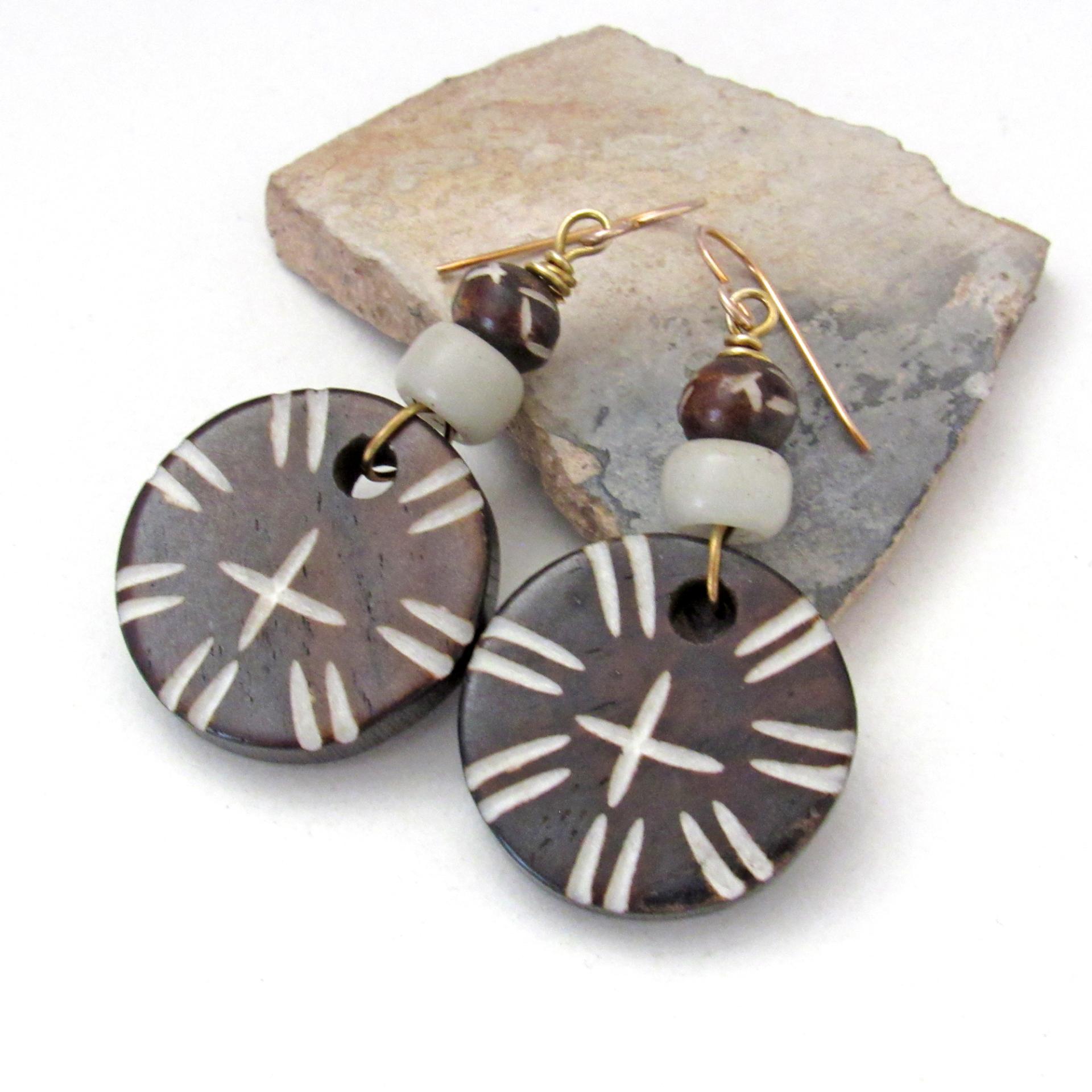 Handmade earrings with large round African batik bone beads with a carved tribal pattern accented with smaller African carved bone beads and African glass beads. 