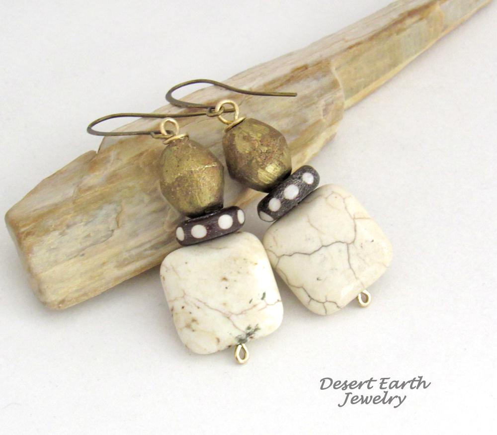 These handcrafted earrings feature natural creamy beige magnesite stones accented with African brass and batik bone beads with a dotted pattern. They have an ethnic tribal, bohemian vibe that makes a unique statement.