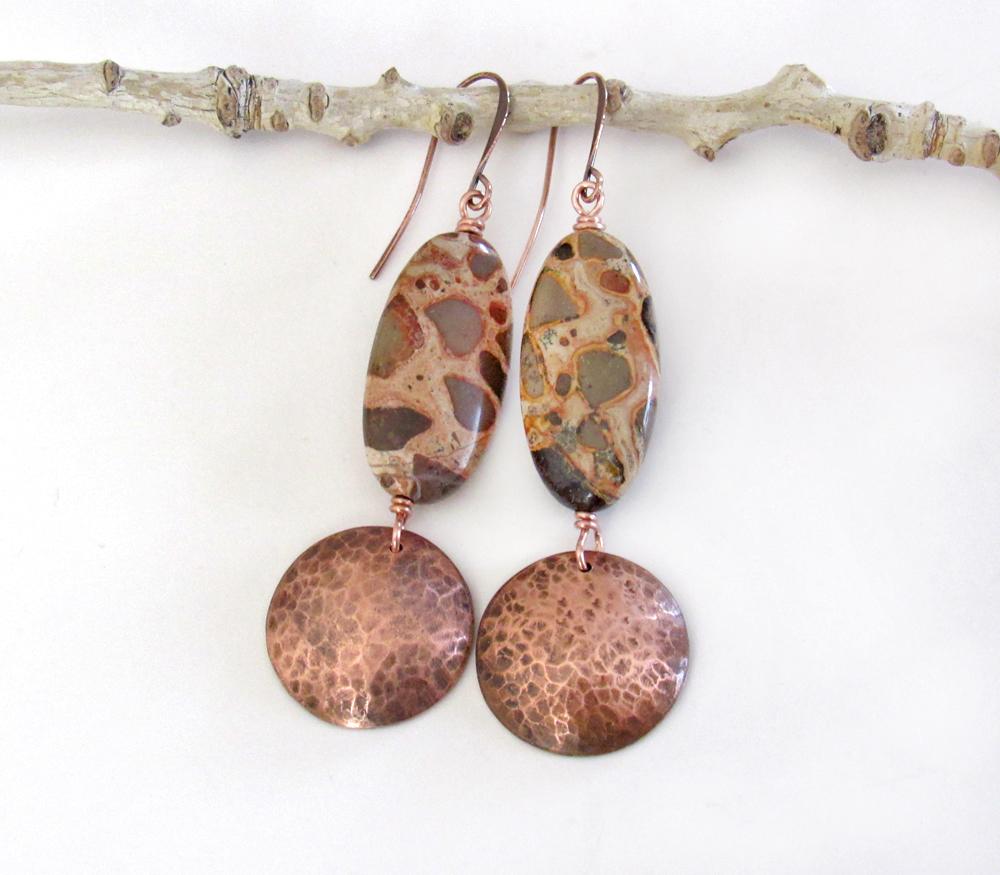 Natural African map jasper stones are accented with hammered copper dangles in these earthy handmade earrings. This type of jasper gets its name because it exhibits the colors and patterns that resemble the markings of the giraffes, cheetahs and other jungle cats that roam Africa. Each stone has its own unique patterns and this pair is no exception with wonderful markings in earthy hues of tan, mossy green, rust, beige and brown.