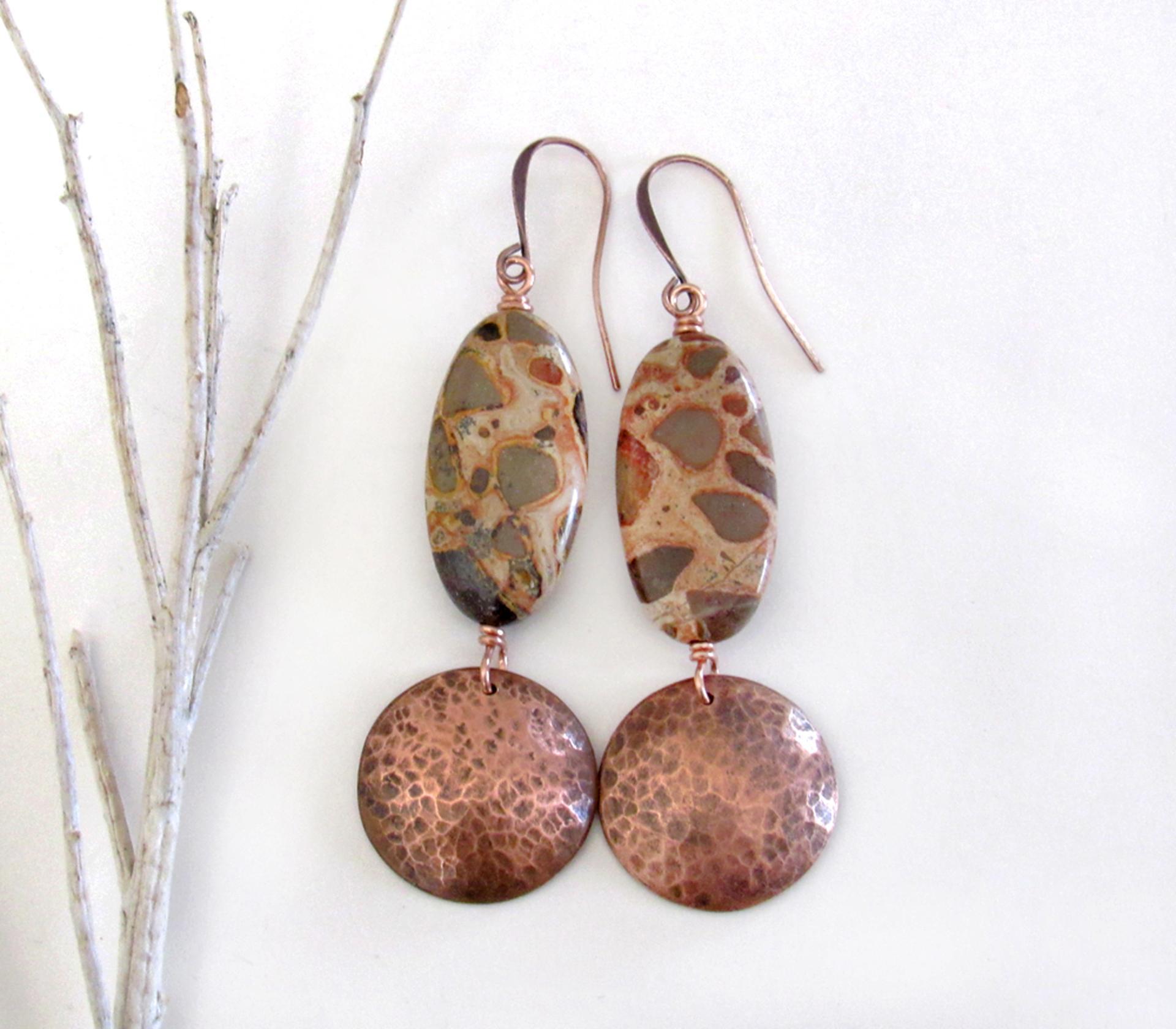Natural African map jasper stones are accented with hammered copper dangles in these earthy handmade earrings. This type of jasper gets its name because it exhibits the colors and patterns that resemble the markings of the giraffes, cheetahs and other jungle cats that roam Africa. Each stone has its own unique patterns and this pair is no exception with wonderful markings in earthy hues of tan, mossy green, rust, beige and brown.