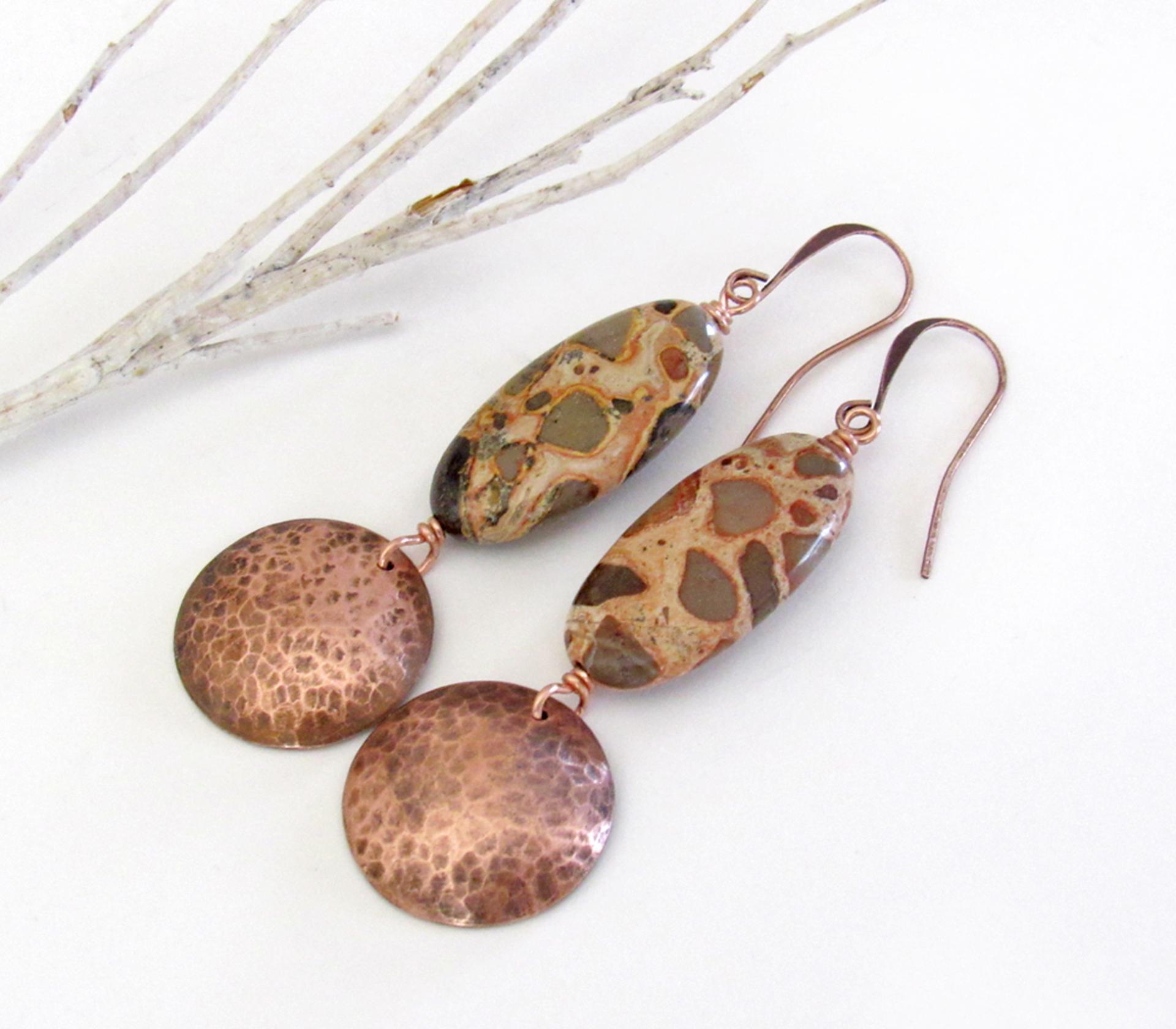 Natural African map jasper stones are accented with hammered copper dangles in these earthy handmade earrings. This type of jasper gets its name because it exhibits the colors and patterns that resemble the markings of the giraffes, cheetahs and other jungle cats that roam Africa. Each stone has its own unique patterns and this pair is no exception with wonderful markings in earthy hues of tan, mossy green, rust, beige and brown.