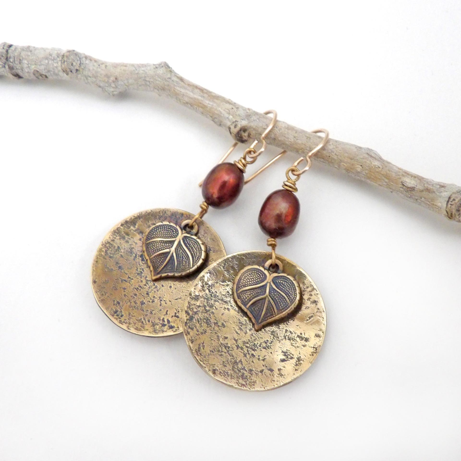 These handcrafted gold brass earrings have a modern, earthy design. They feature tiny brass leaves dangling in front of gold brass dangles accented with shimmery bronze pearls. Makes a great gift for a nature lover or yourself! Perfect for your fall wardrobe - or any time of year. Handmade in the USA by Desert Earth Jewelry.