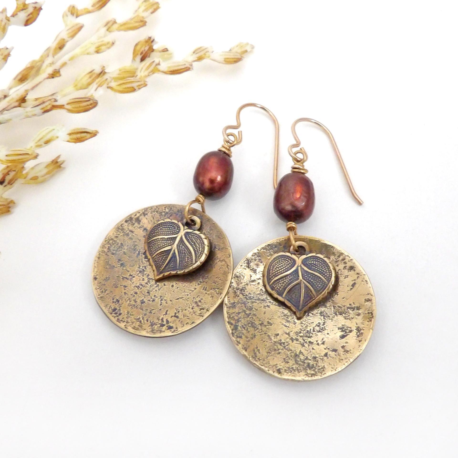 These handcrafted gold brass earrings have a modern, earthy design. They feature tiny brass leaves dangling in front of gold brass dangles accented with shimmery bronze pearls. Makes a great gift for a nature lover or yourself! Perfect for your fall wardrobe - or any time of year. Handmade in the USA by Desert Earth Jewelry.