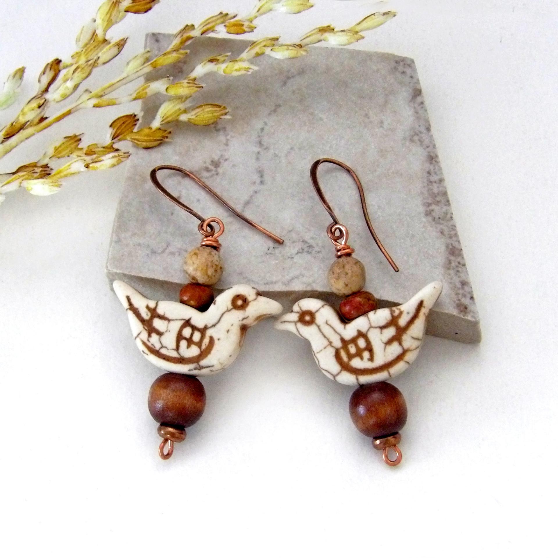 These handmade earrings feature creamy beige magnesite stone birds. They are accented with brown jasper, picture jasper, brown wood and tiny copper beads. Super cute, whimsical and fun to wear -- they'll make a great gift for a nature / bird lover! Your choice of ear wires - copper or hypoallergenic niobium.
