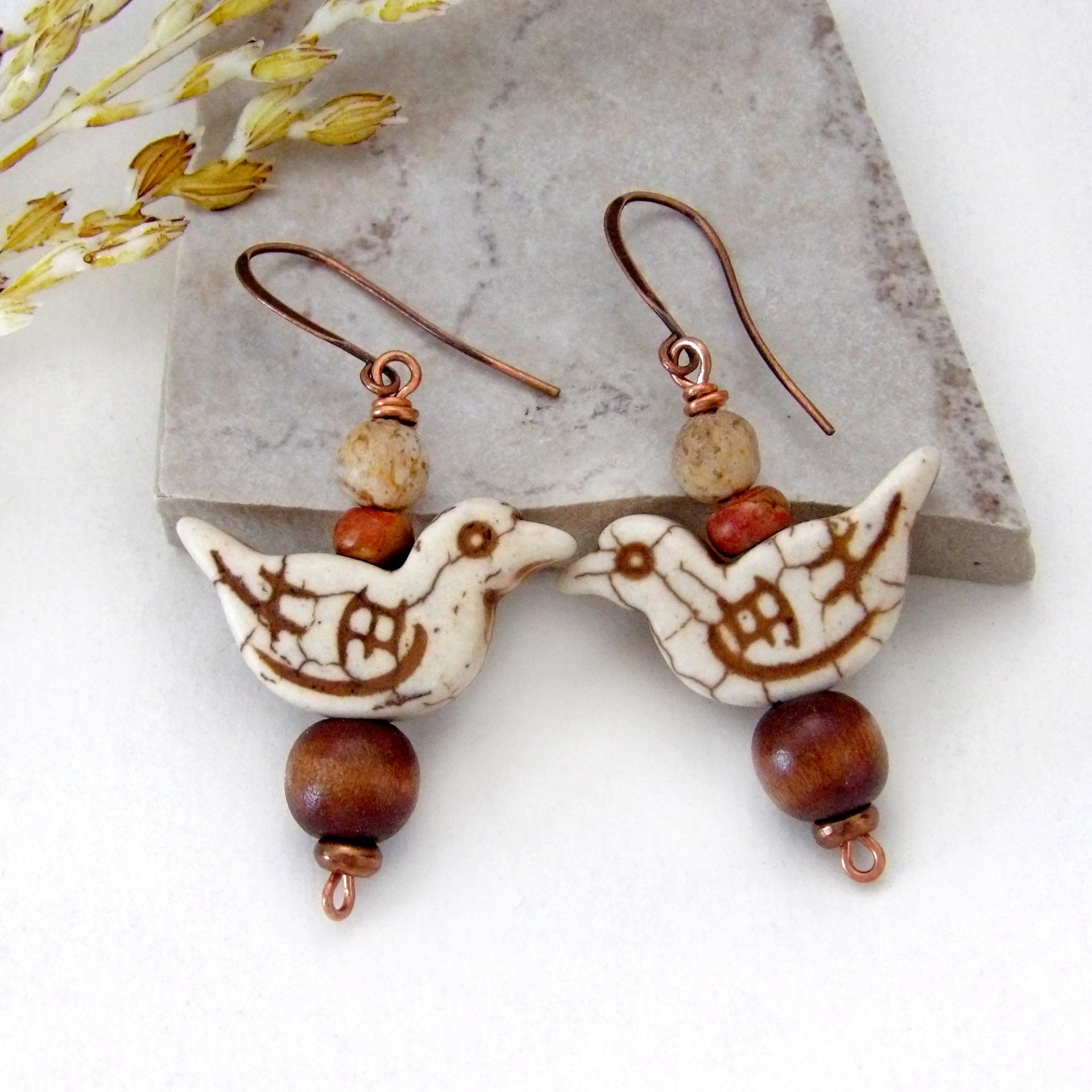 These handmade earrings feature creamy beige magnesite stone birds. They are accented with brown jasper, picture jasper, brown wood and tiny copper beads. Super cute, whimsical and fun to wear -- they'll make a great gift for a nature / bird lover! Your choice of ear wires - copper or hypoallergenic niobium.