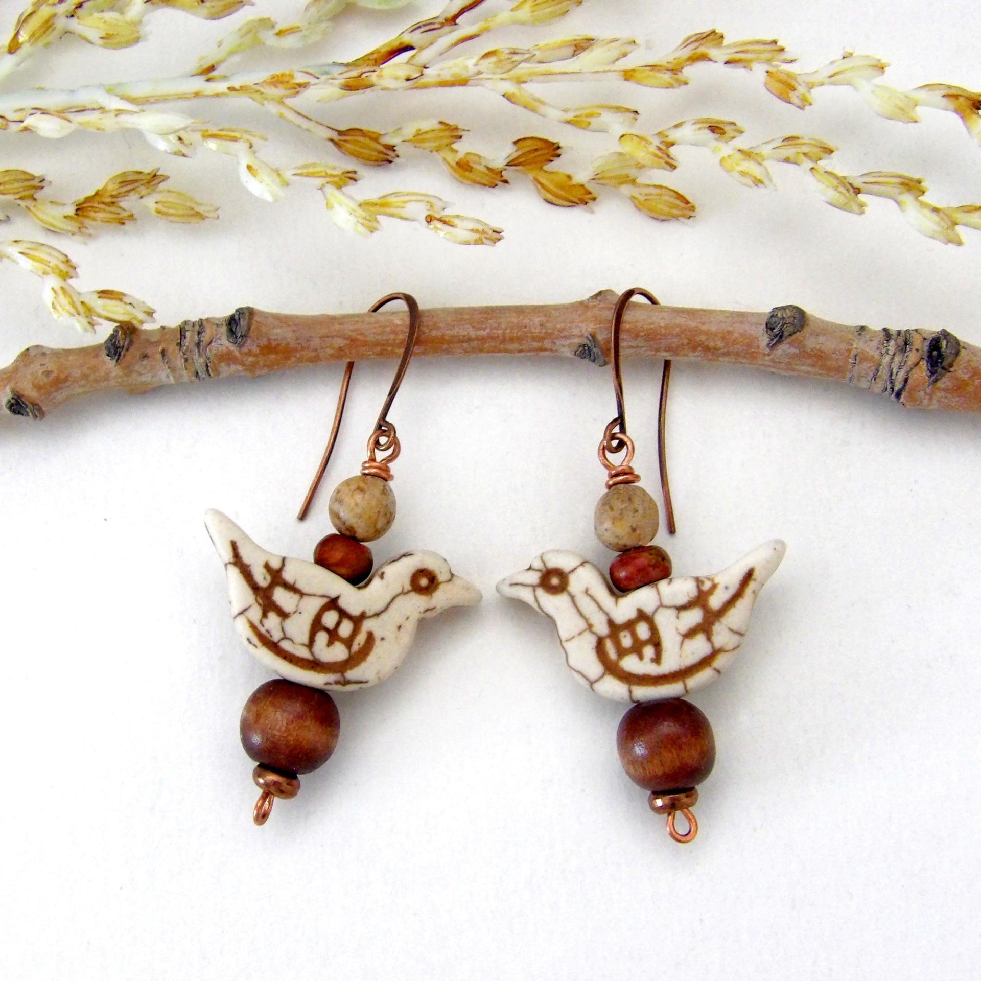 These handmade earrings feature creamy beige magnesite stone birds. They are accented with brown jasper, picture jasper, brown wood and tiny copper beads. Super cute, whimsical and fun to wear -- they'll make a great gift for a nature / bird lover! Your choice of ear wires - copper or hypoallergenic niobium.