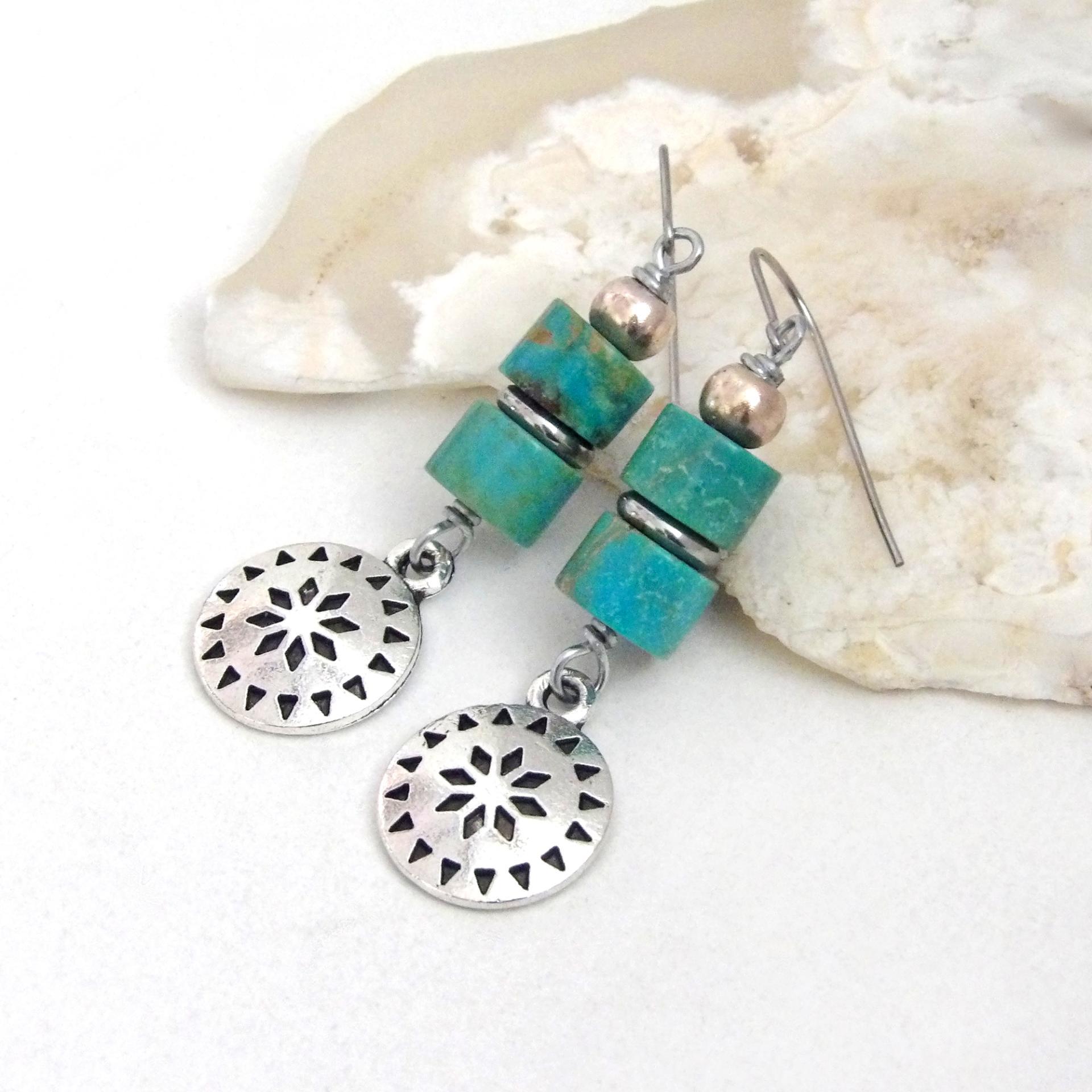 These handmade dangle earrings feature silver tone pewter concho charms accented with a stack of turquoise stones and pewter beads. Lightweight and fun to wear, they'll add a touch of southwestern charm to your wardrobe. Perfect for women that love southwest and sundance style jewelry. 