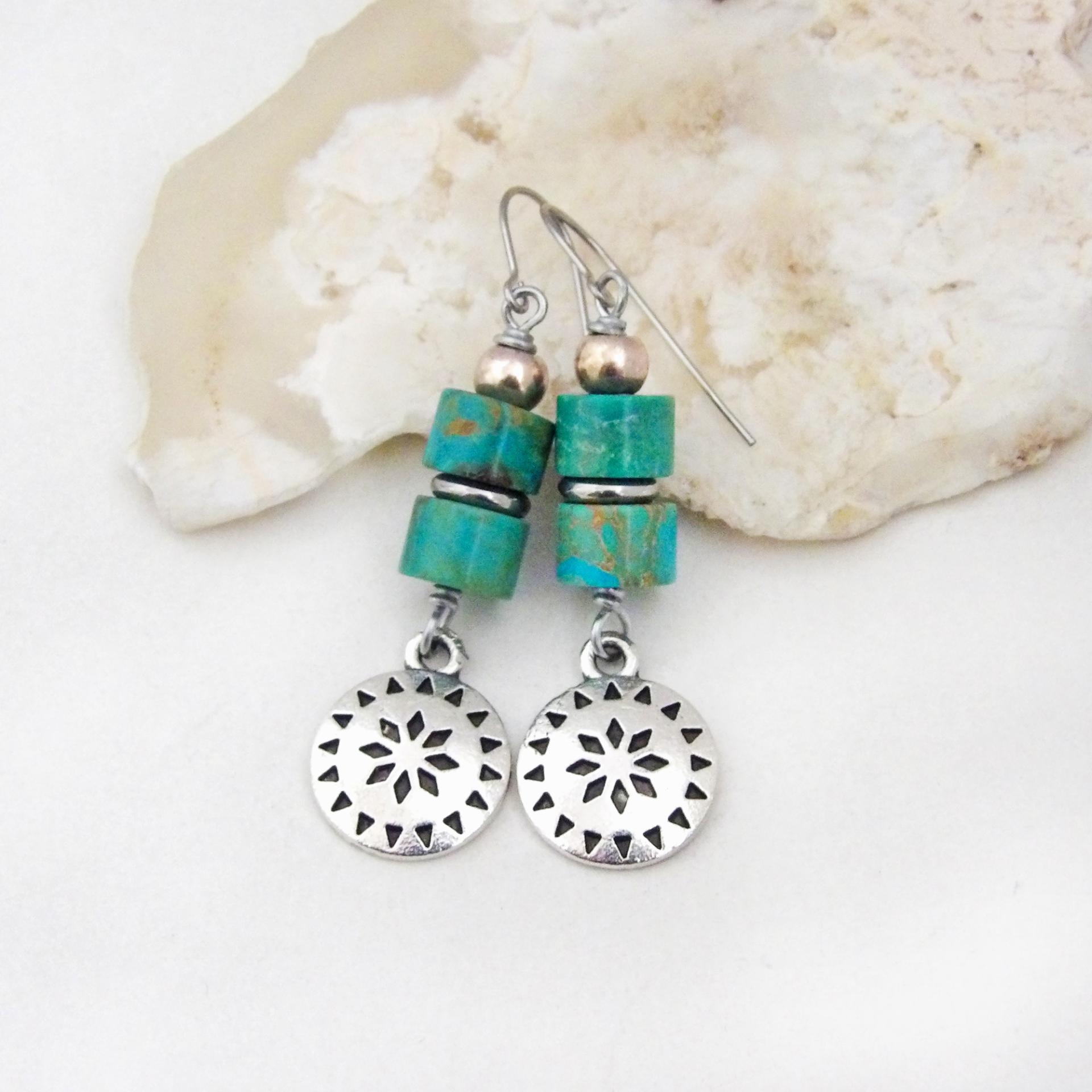 These handmade dangle earrings feature silver tone pewter concho charms accented with a stack of turquoise stones and pewter beads. Lightweight and fun to wear, they'll add a touch of southwestern charm to your wardrobe. Perfect for women that love southwest and sundance style jewelry. 