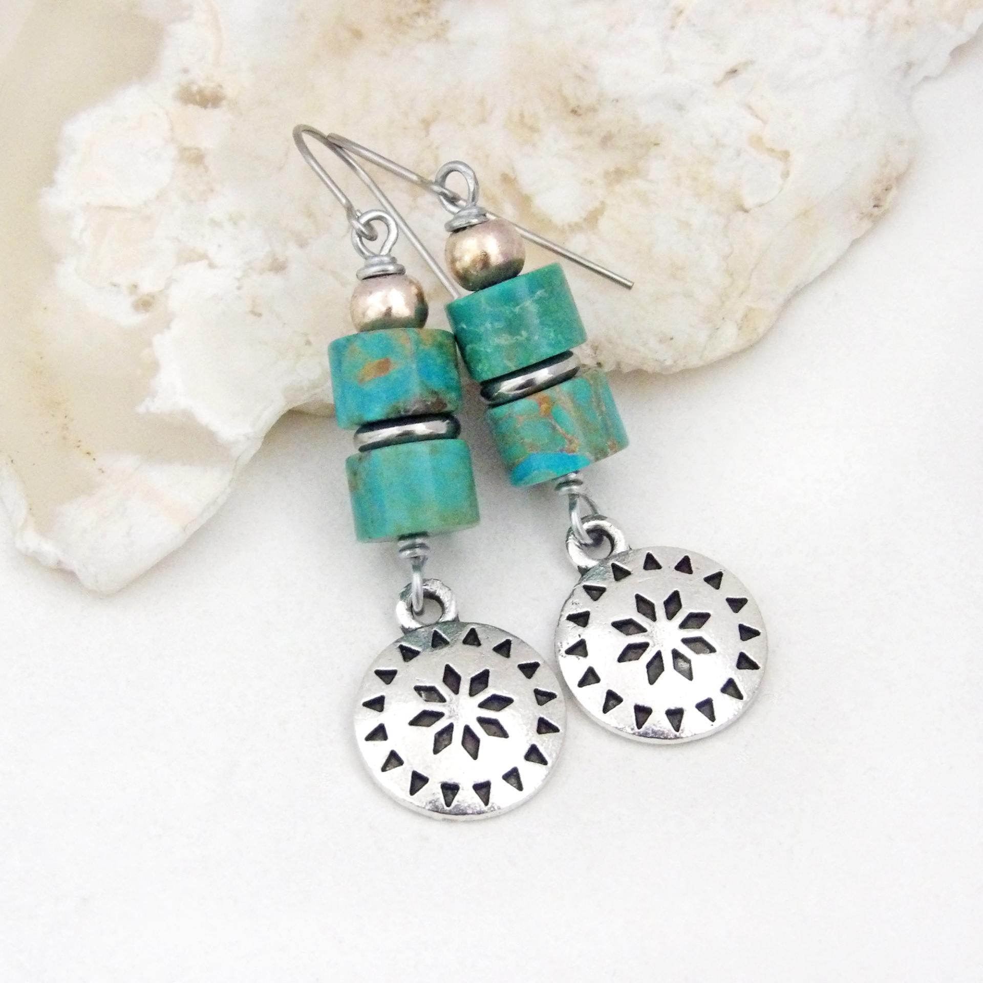 These handmade dangle earrings feature silver tone pewter concho charms accented with a stack of turquoise stones and pewter beads. Lightweight and fun to wear, they'll add a touch of southwestern charm to your wardrobe. Perfect for women that love southwest and sundance style jewelry. 