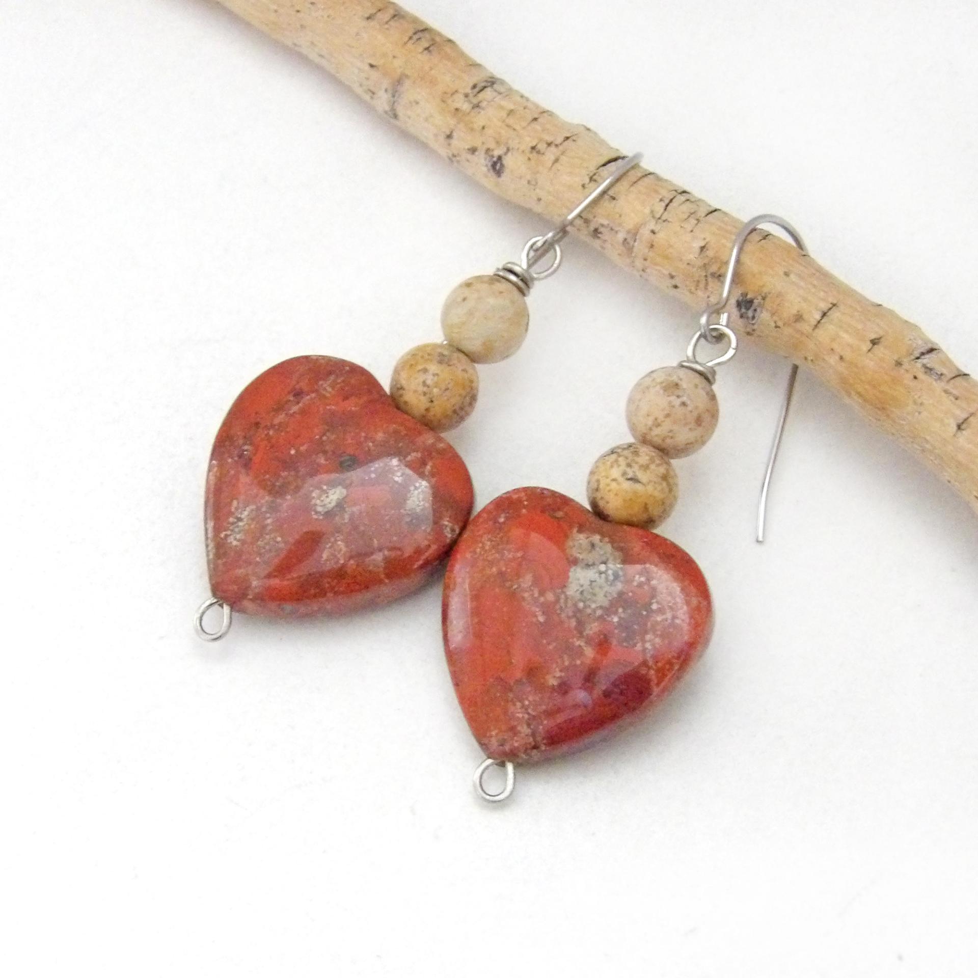 These handmade earrings feature heart shaped brecciated red jasper gemstones accented with beige picture jasper stones on surgical steel ear wires. This type of jasper has a brick red hue with natural inclusions. Full of romantic charm - they'll make a great gift for Valentine's Day, Mother's Day, a wedding anniversary, or simply to say "I love you".