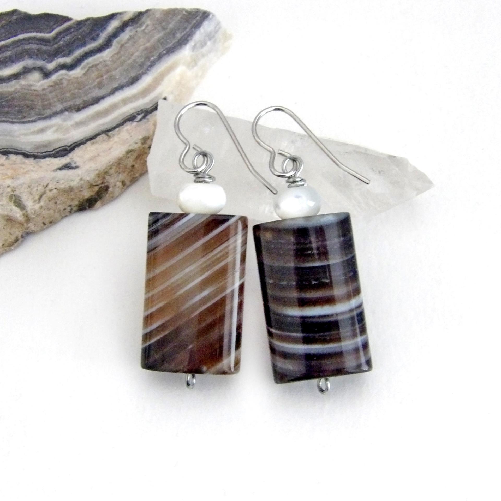 Simple, yet elegant - these earrings feature natural sardonyx gemstones with a striking natural black and white striped pattern accented with white moonstones. Sardonyx is a type of agate formed when minerals form in between strips of black onyx which gives the stone a banded, "striped" appearance. The modern, elegant style will look great dressed up or down. They'll make a great gift for someone with an August birthday - sardonyx is the original and oldest recorded birthstone for August.