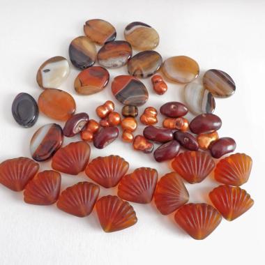 Mixed bead lot for jewelry making / beading / craft supply.  Lot consists of 14 pieces of oval-shaped banded agate beads (black orange white tones with various matrix patterns). Measures approximately 7/8" to 1" in length and 3/4" in width - drilled top to bottom. 12 pieces of burnt orange seashell shaped beads. Measures approximately 1" at widest point and 3/4" in length - drilled top to bottom 9 bright orange organically shaped freshwater pearl beads - drilled 8 dark reddish-brown dried bean beads