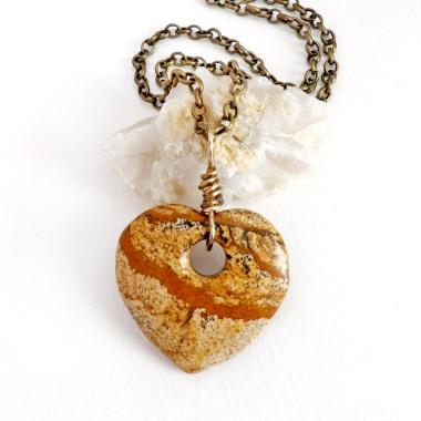 This handcrafted pendant necklace has a simplistic earthy charm. It features a natural picture jasper gemstone carved into a heart shape. It's wrapped in antiqued brass wire and comes on an 18" antiqued brass chain. The stone has a natural pattern with markings of tan, mocha brown and black. Makes a great gift to tell someone "I love you" - or a nice addition to your own jewelry collection.